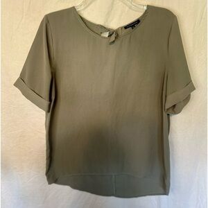 Staccato green blouse with tie back closure. Size large